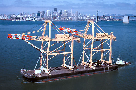 Barge departing with 2 container cranes on deck