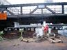 Barge maneuvered under bridge at low tide